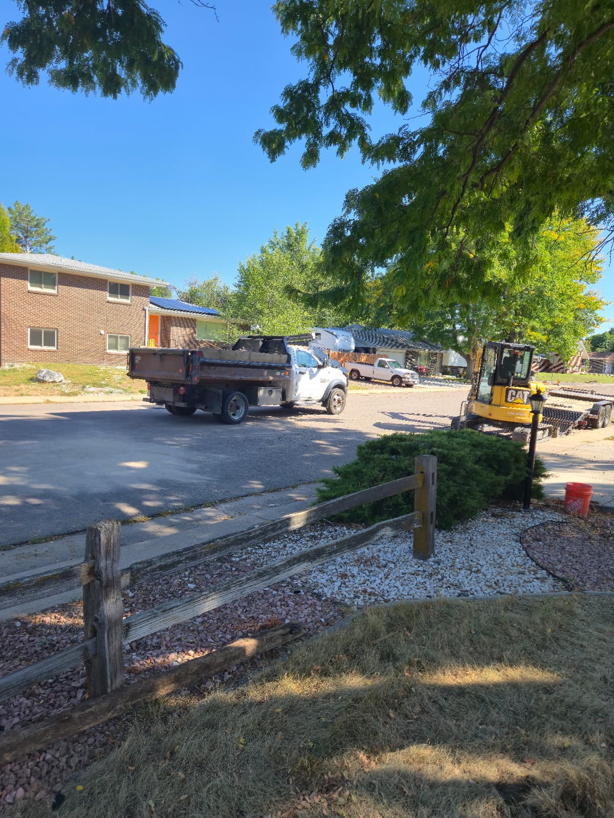 Sewer repair equipment and work vehicles at a residential project